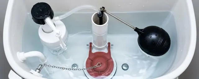 Open toilet tank showing the fill valve, flapper, chain and float